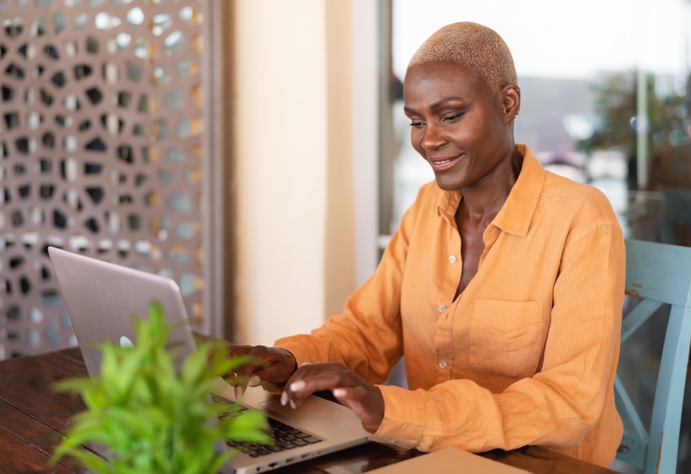 African,Woman,Working,On,Laptop,In,Bar,Restaurant,-,Afro